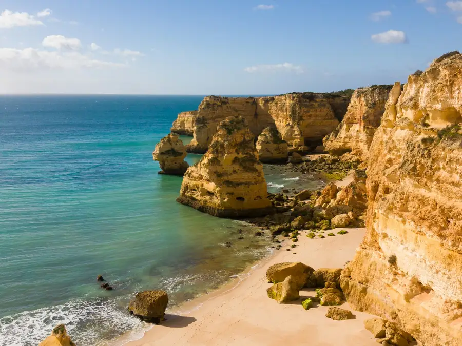 Golden cliffs and turquoise sea at Praia da Marinha in the Algarve